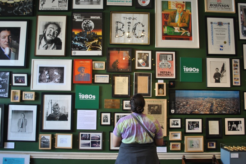 A visitor stands before a wall of memorabilia from throughout Dublin's history at The Little Museum in Dublin, Ireland.